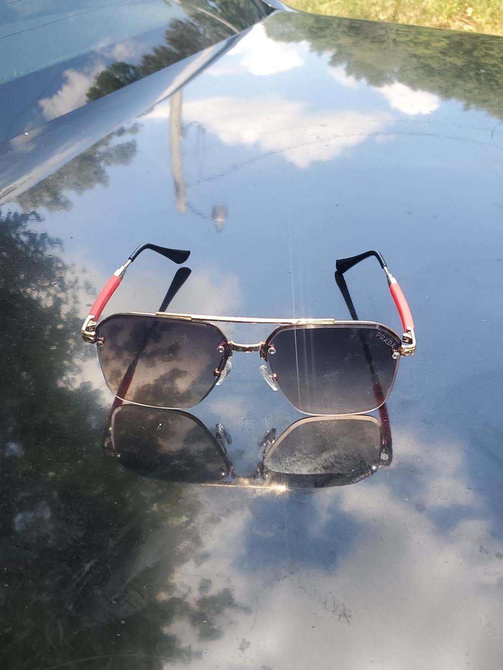 Prada Men’s Aviator Sunglasses - Black Gradient Lenses with Red Temples